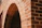 Close-up of elegant Spanish-style brickwork with warm earthy tones under soft tropical sunlight.