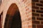 Close-up of elegant Spanish-style brickwork with warm earthy tones under soft tropical sunlight.