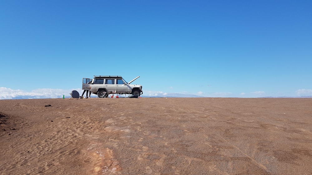 white SUV broke down in the middle of desert