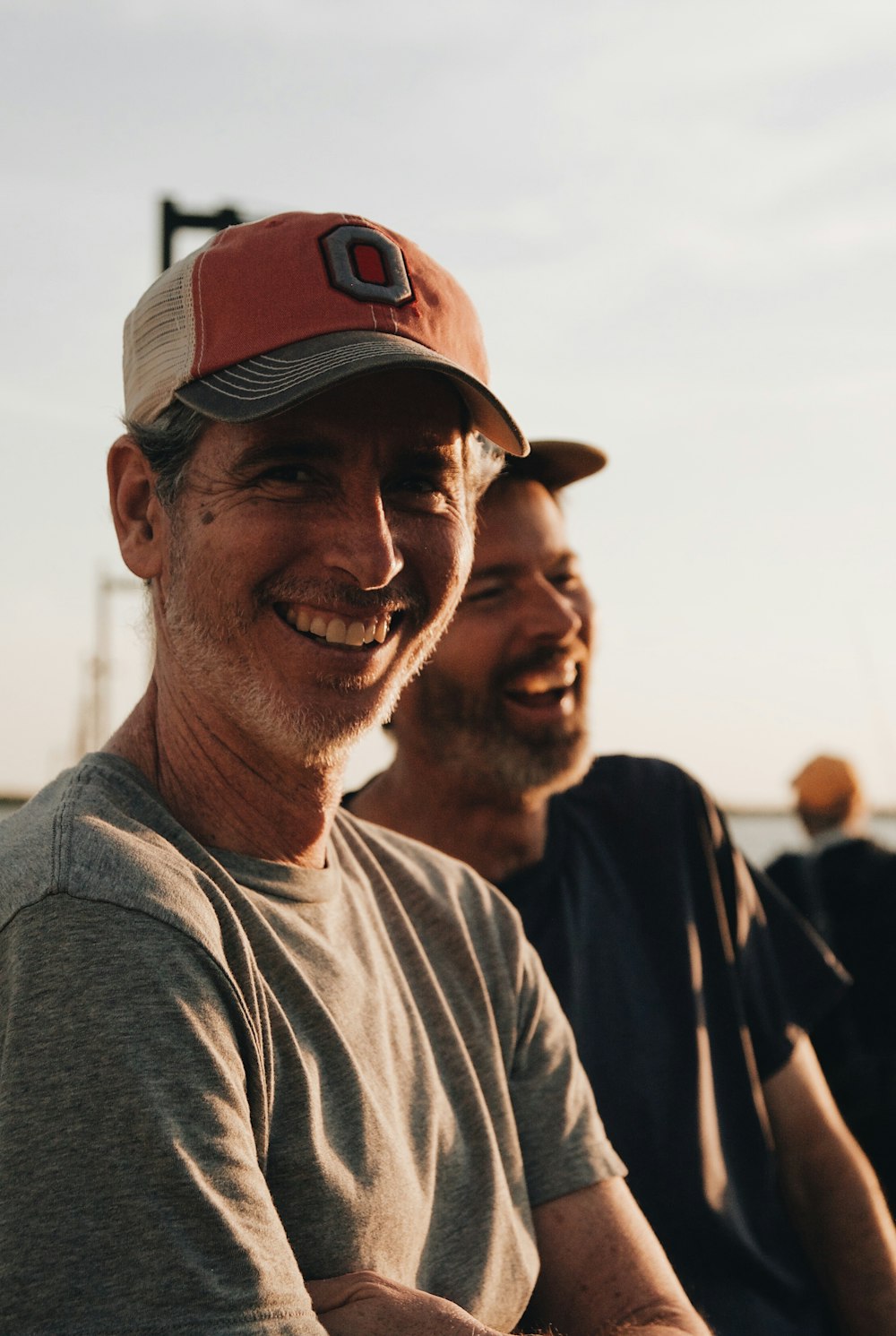 man wearing orange curved brim cap