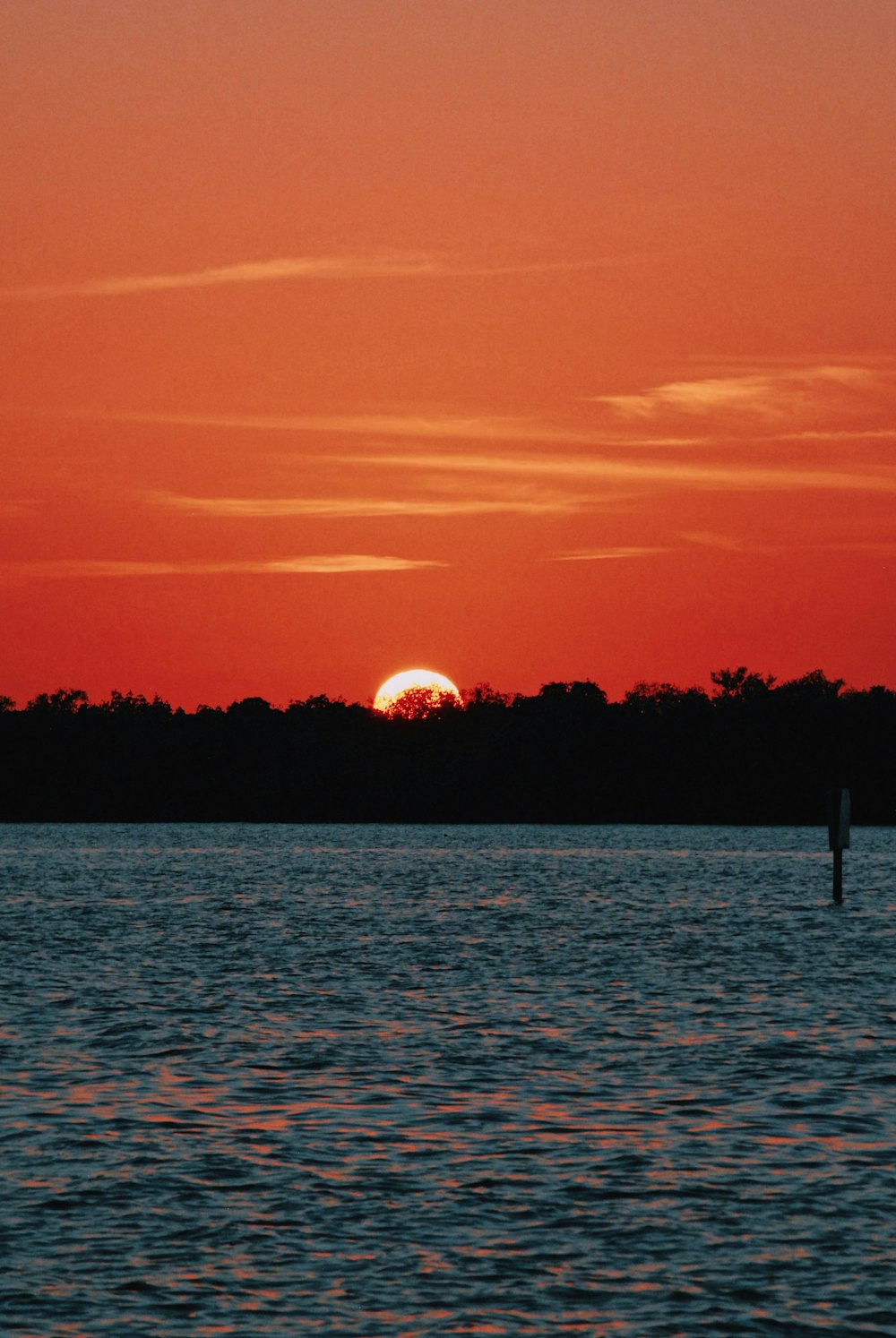 red sky and sun and blue water