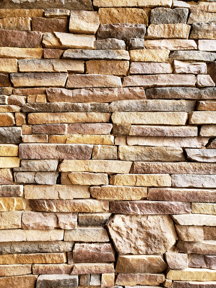 A warm-toned natural stone strip cladding wall.
