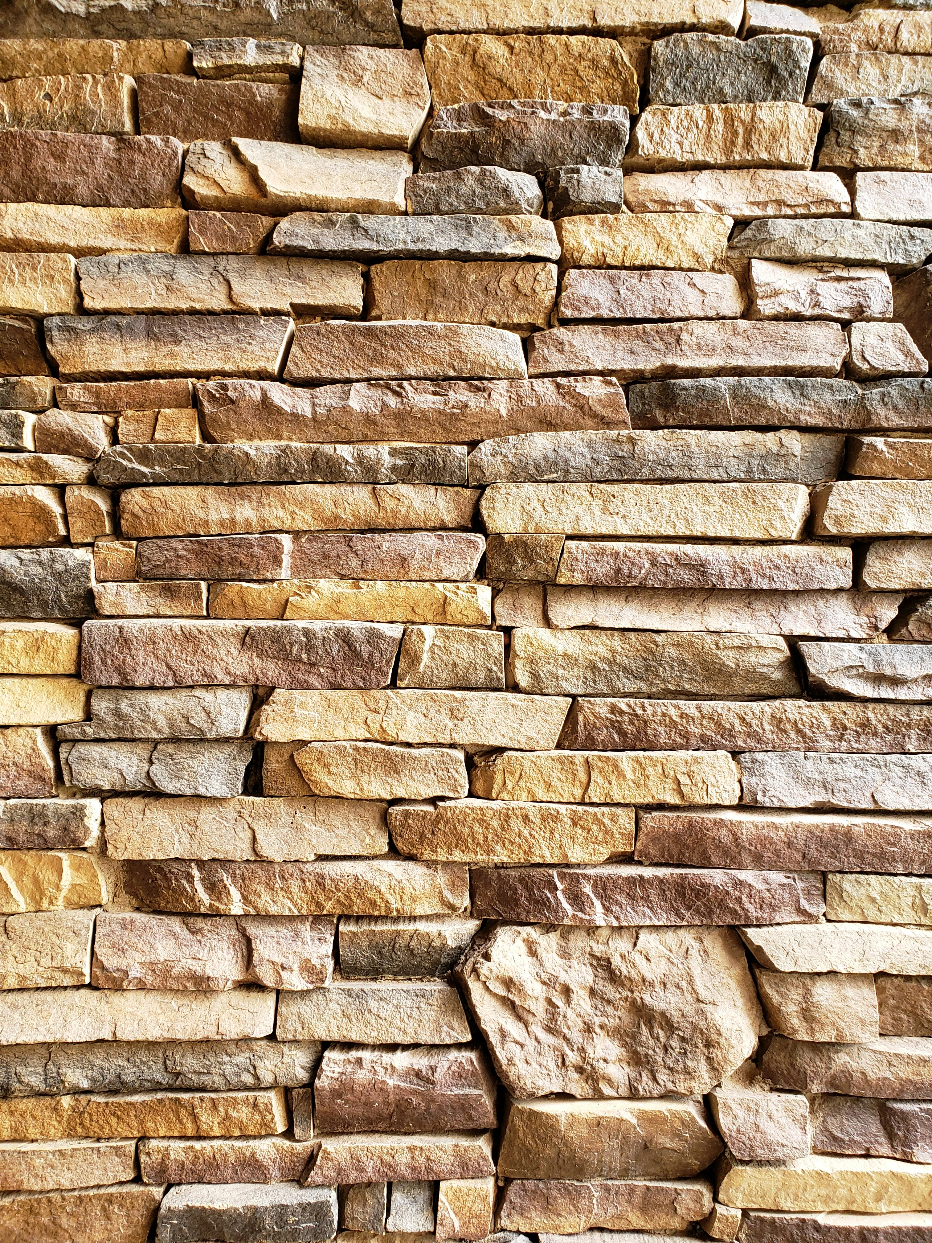 cream and brown colored stone wall