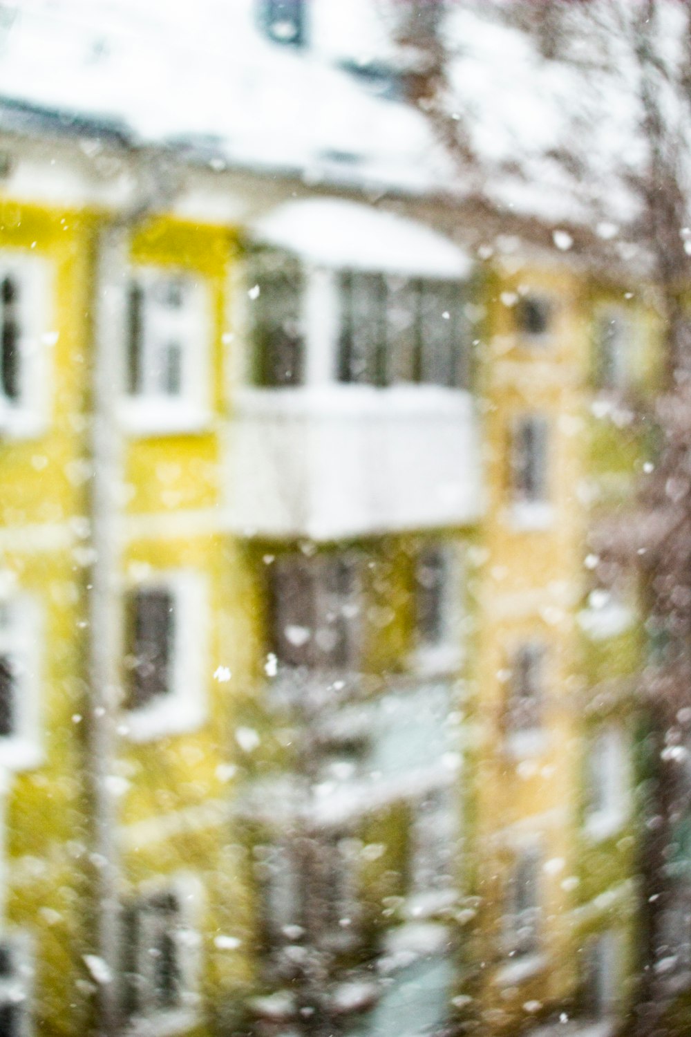 a window view of a building with snow on it