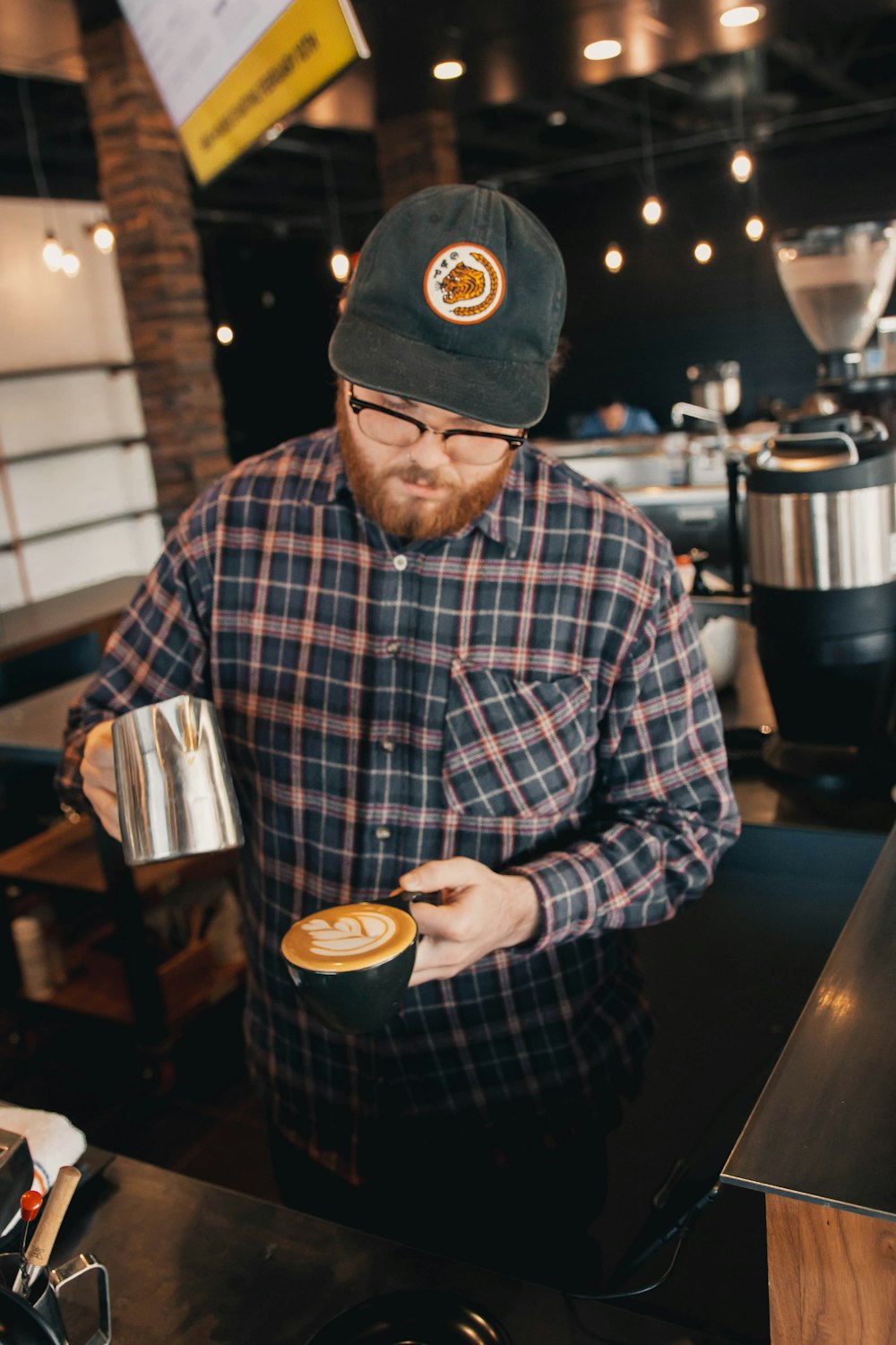 a man standing in a restaurant holding a cup of coffee