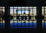 Office door with a large window panel showing a busy office interior.