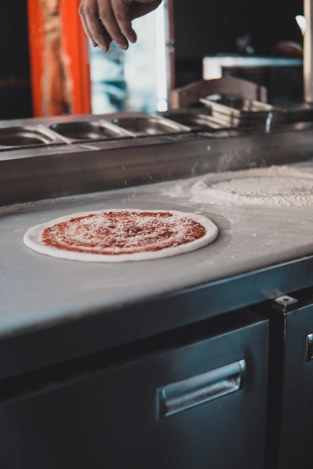 a pizza being made on a pizza stone