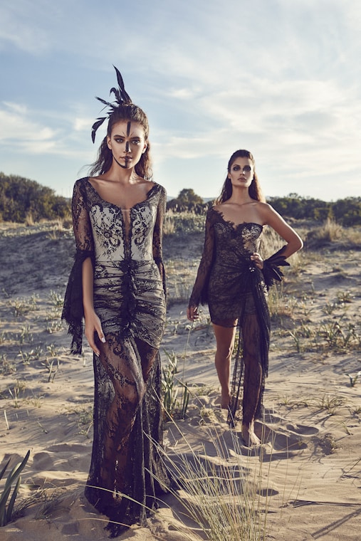 Model wearing bohemian dress with fringe details in natural setting