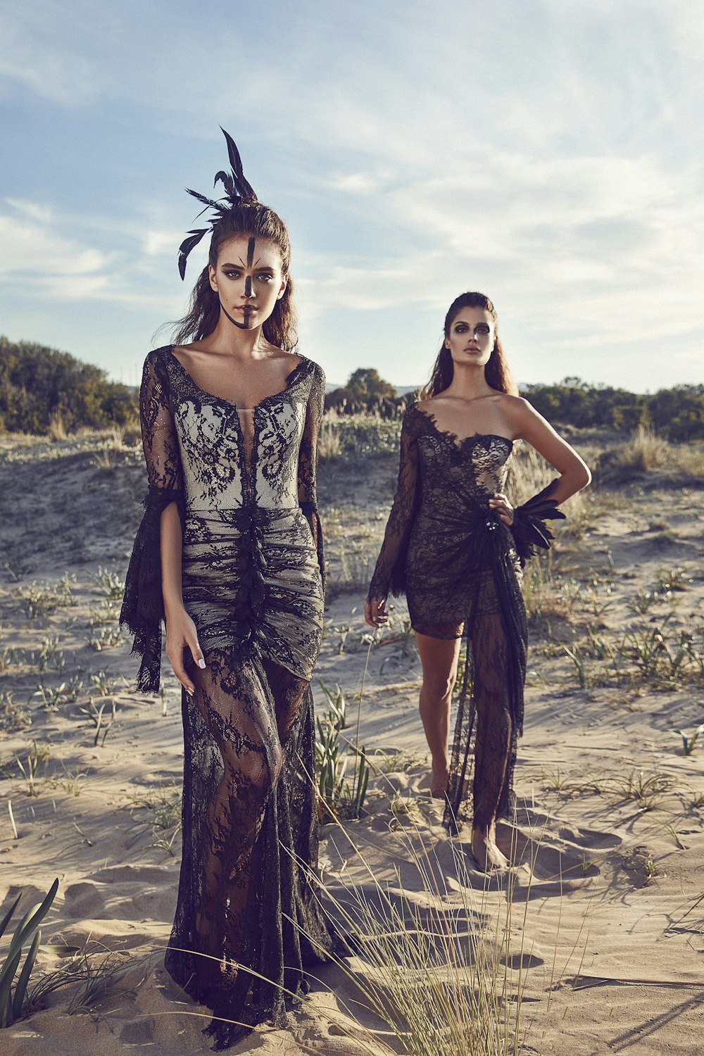 women wearing black lace dresses in dessert