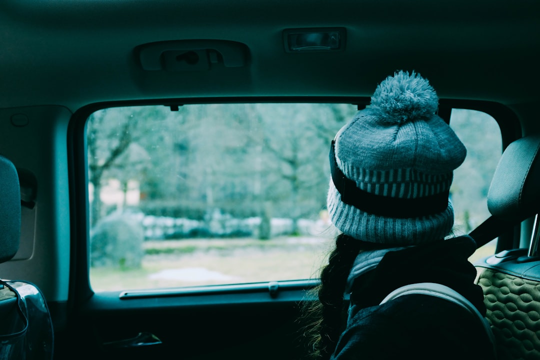 woman wearing knit cap sitting inside vehicle