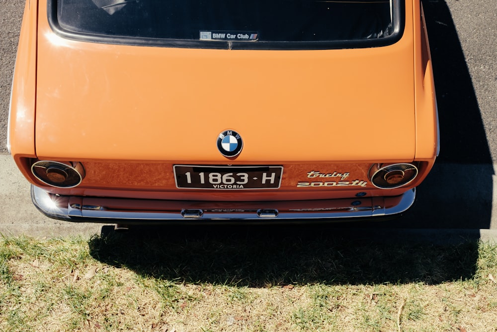 orange classic BMW sedan parked