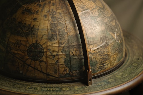 Global map highlighting key trading routes across continents with muted gold accents.