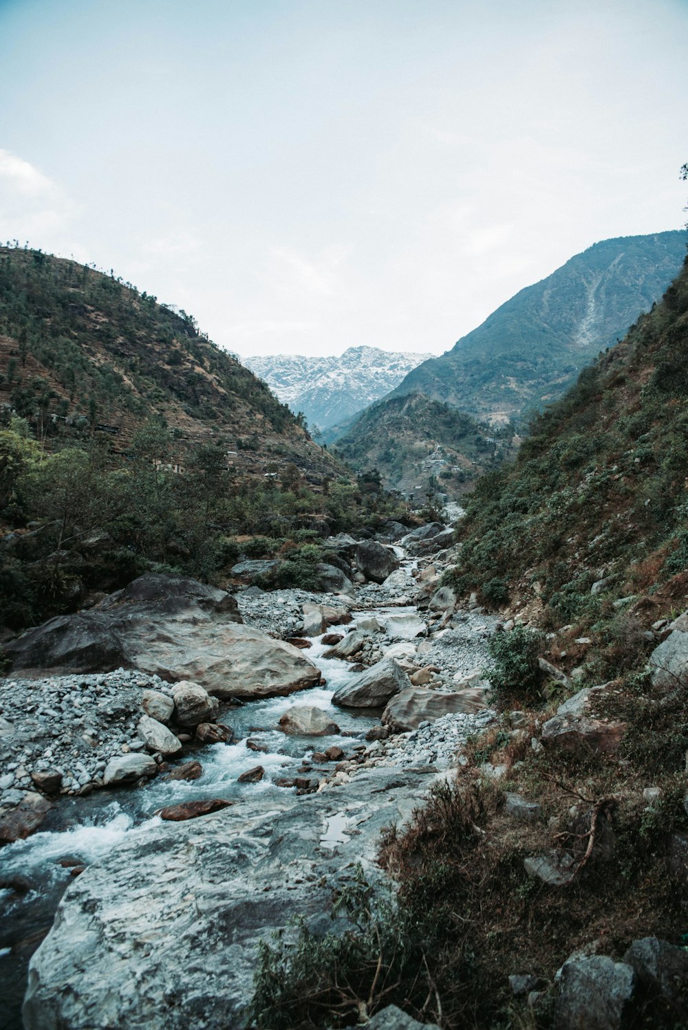 river near mountain at daytime