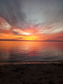 A breathtaking sunset over a tranquil beach, capturing the essence of a perfect vacation moment.