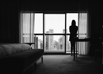 silhouette of woman standing on veranda