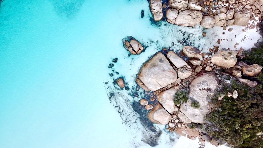aerial photography of seashore with rocks