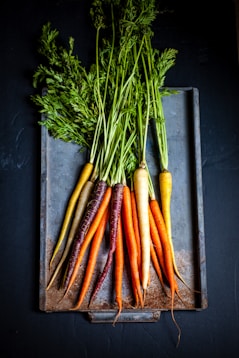 a bunch of carrots sitting on top of a cutting board
