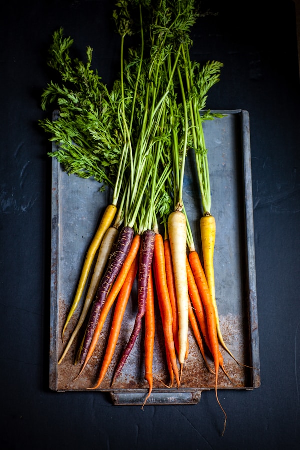 a bunch of carrots sitting on top of a cutting boardby Heather Gill