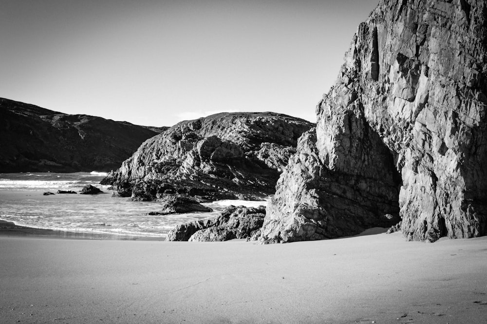 grayscale photography of rock formation