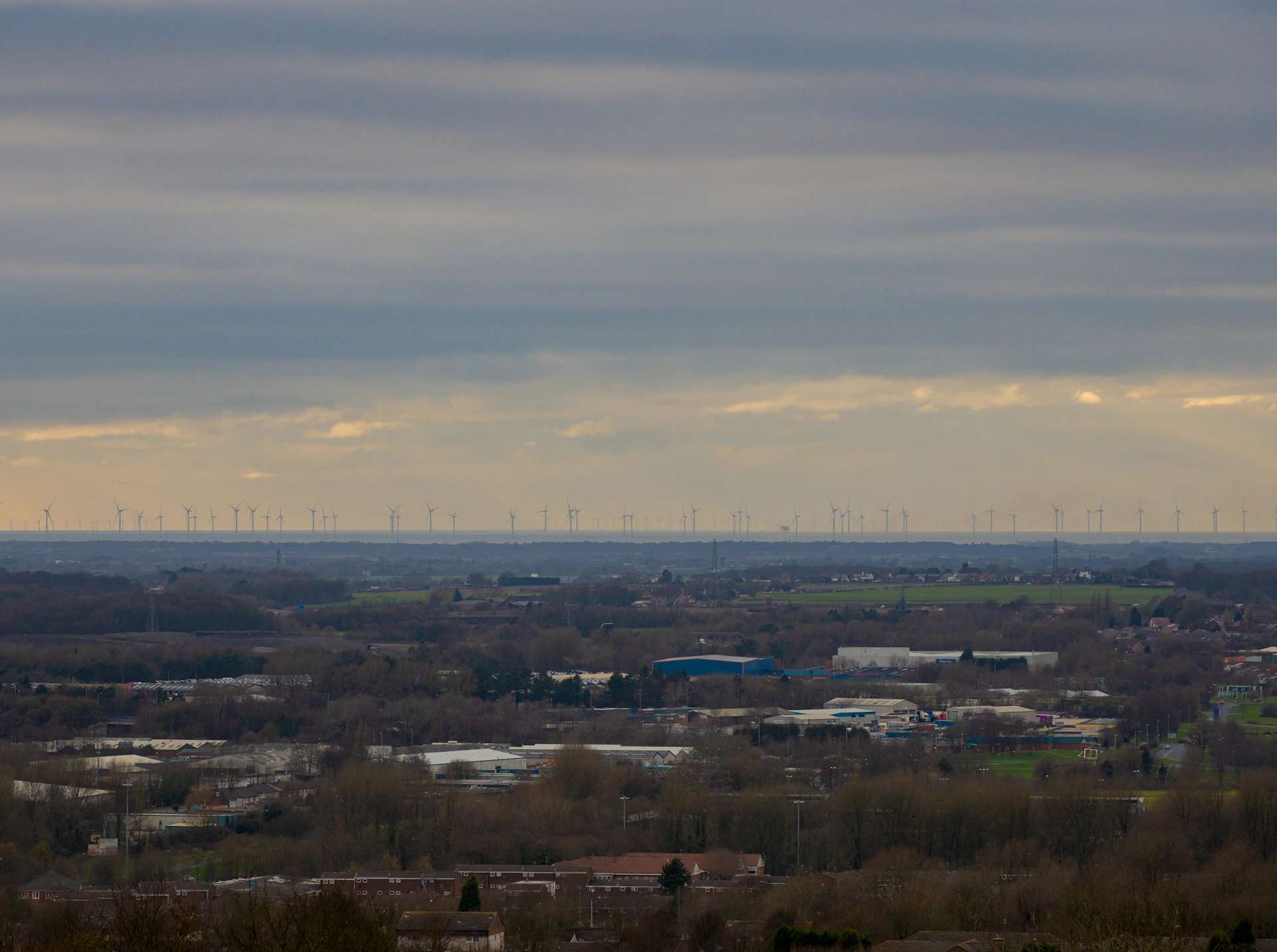 woman wearing yellow long-sleeved dress under white clouds and blue sky during daytime