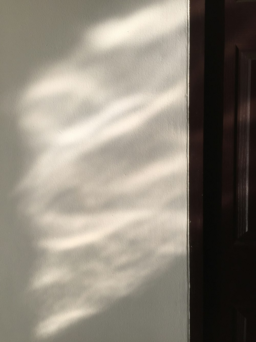 the shadow of a door on a wall