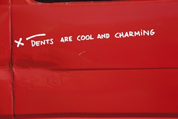 a sticker on the side of a red vehicle