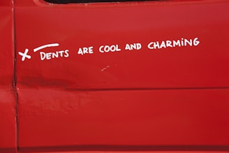 a sticker on the side of a red vehicle