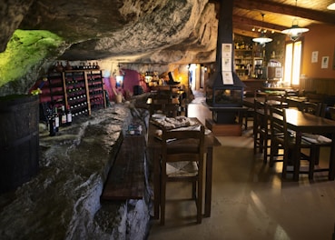 Elegant suite interior featuring stone walls and plush furnishings with a view of the private wine cellar.