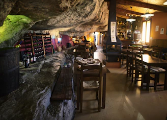 Cozy wooden interior of Le Grenier with warm lighting and rustic Swiss decor.