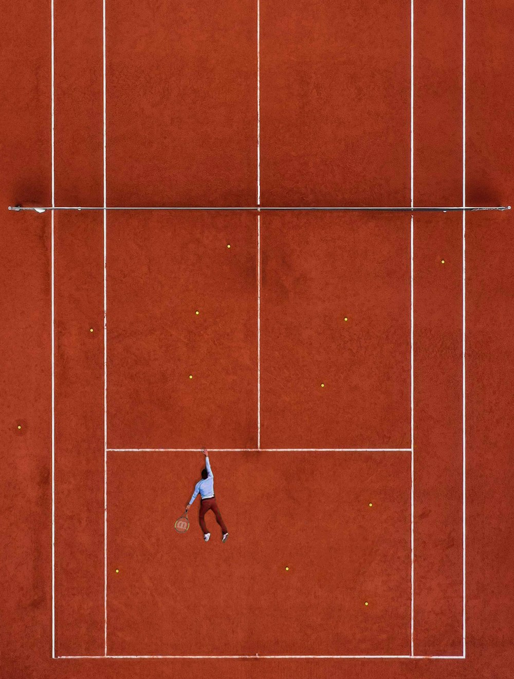 man lying on tennis field