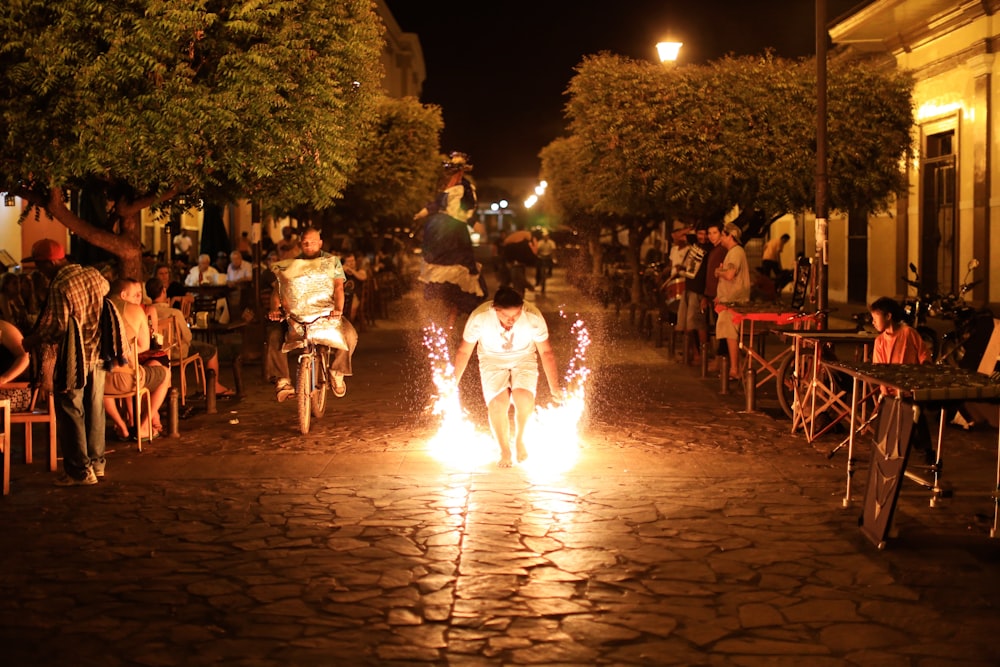 man holding sparkler on street