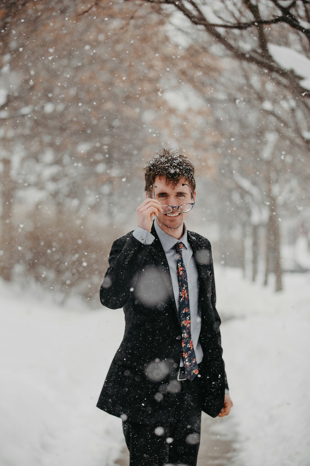 man in black blazer standing on selective focus photography