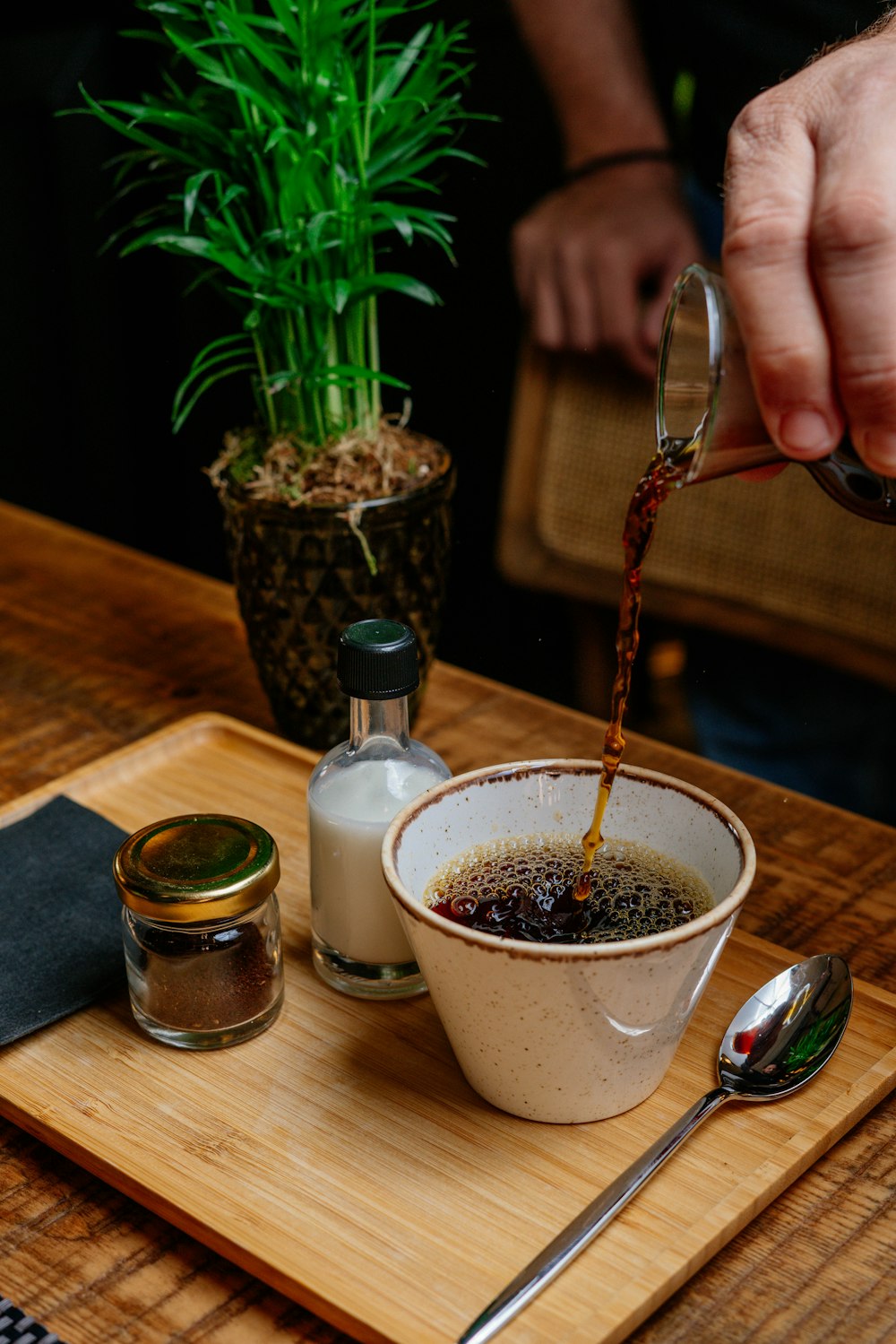 person pouring coffee on cup