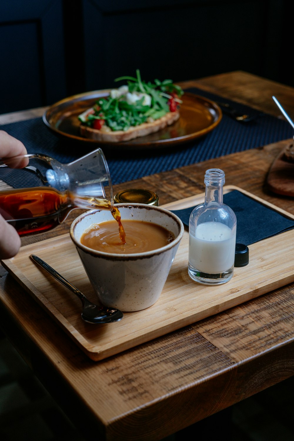 person pouring on white ceramic mug