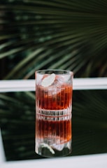 clear glass cup with brown liquid