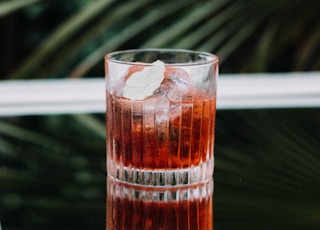 clear glass cup with brown liquid