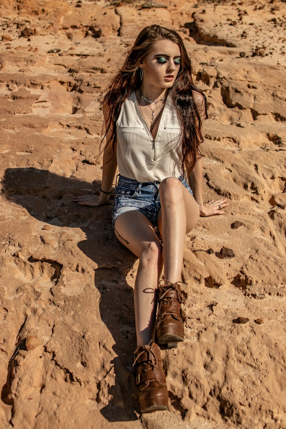 woman sitting on rock during daytime