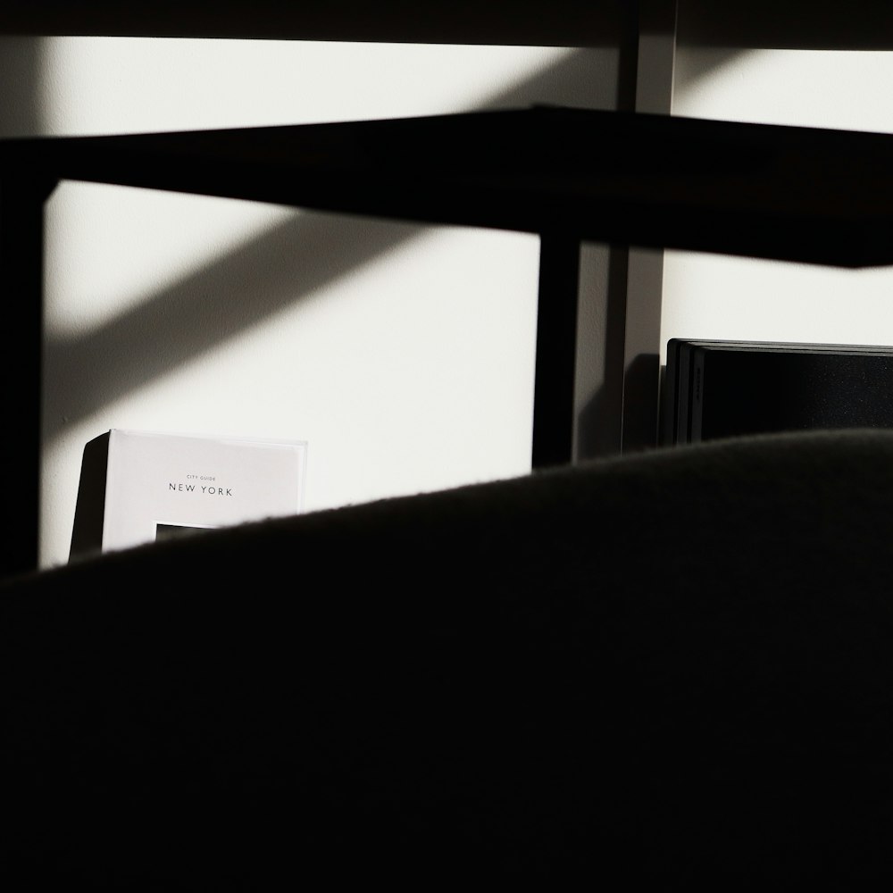 a black and white photo of a desk and chair