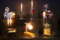 A variety of vintage projectors and mechanical objects are creatively transformed into lamps. The setup features six unique lamps, each with its own style and base, including film reels and gears. The lamps emit a warm, ambient light, casting a cozy glow.