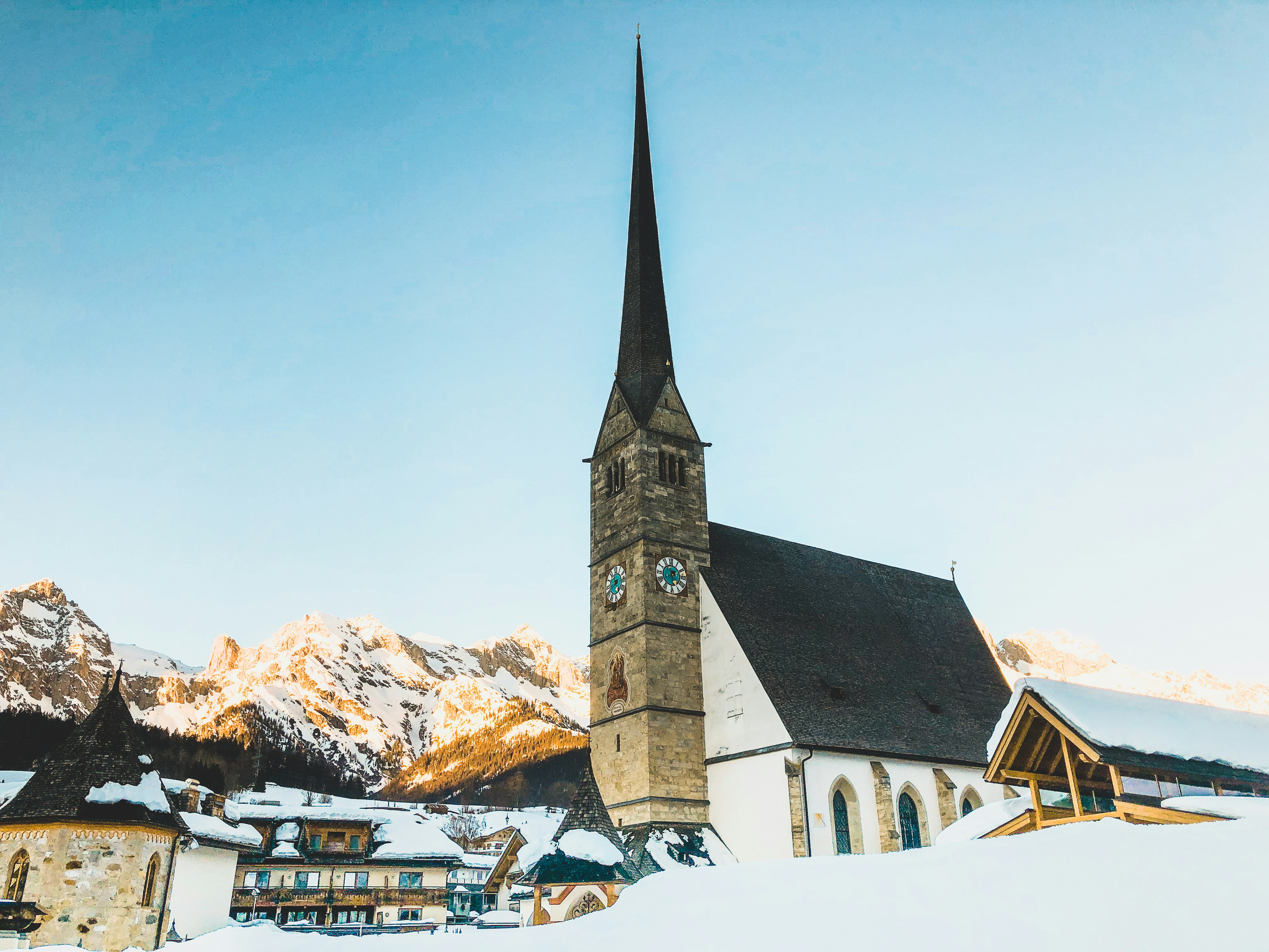 brown and white concrete house near mountains