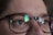 Close-up of a person wearing modern eyeglasses in natural light.