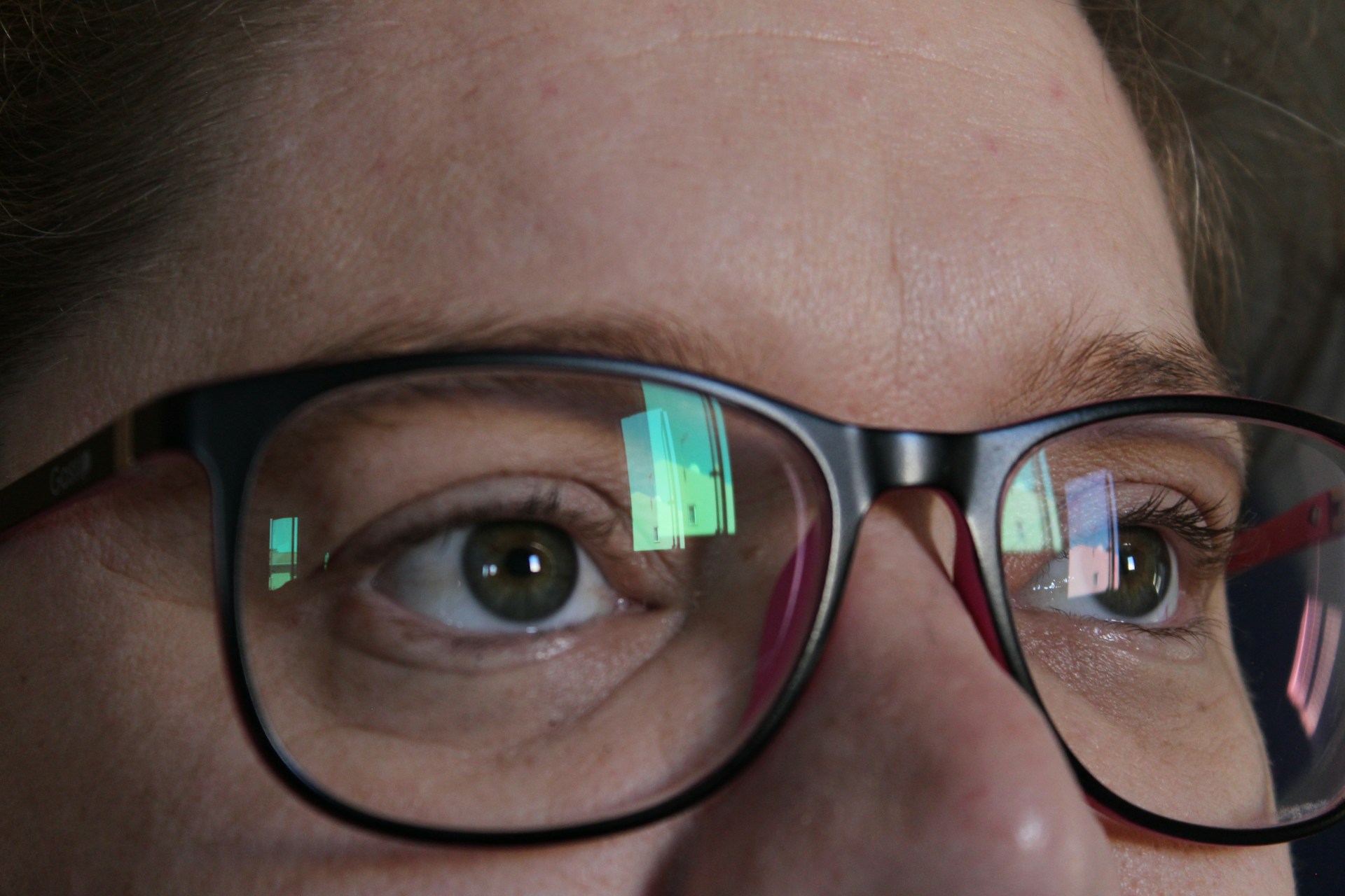 A close-up of a customer trying on glasses in the store.