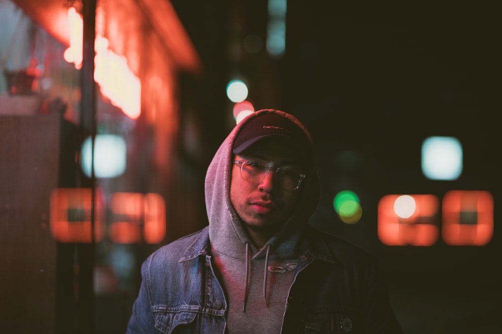 man in blue denim jacket and black fitted cap