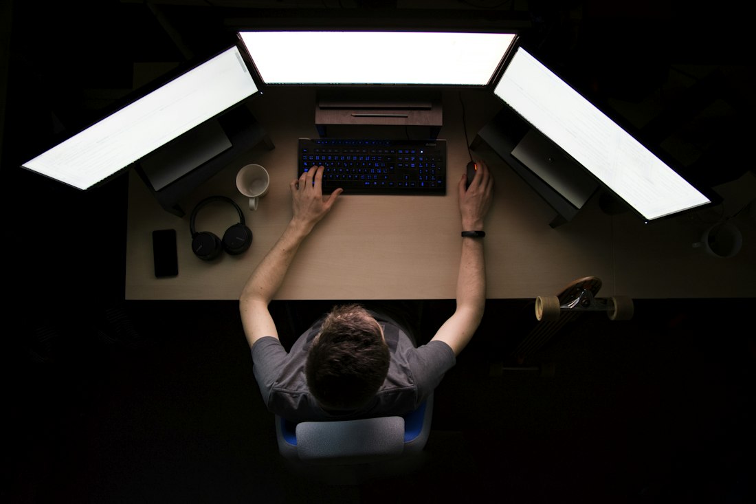 Person organizing files on a laptop with folders visible on screen