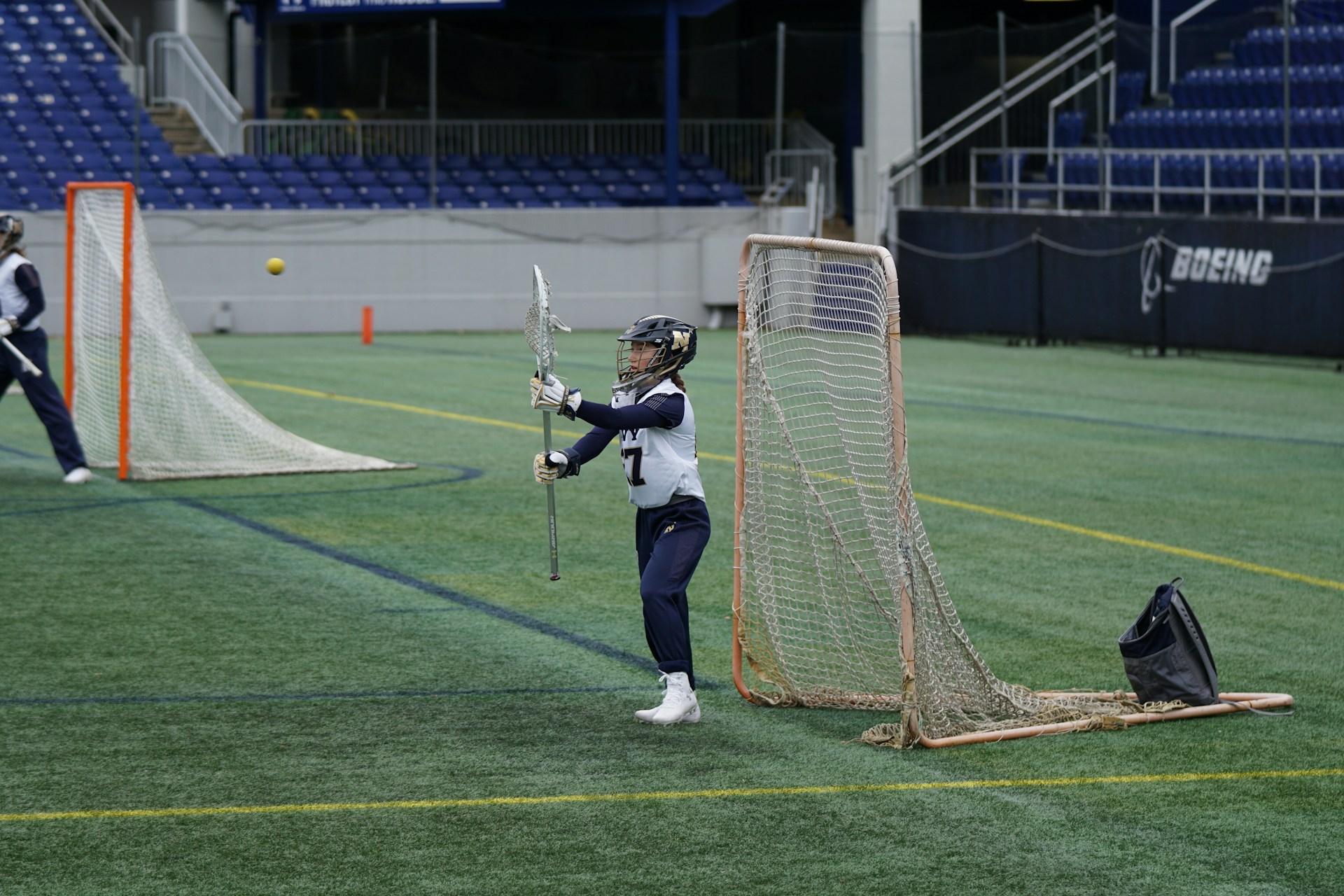 person holding lacrosse stick in field