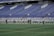 A group of athletes wearing matching custom sports uniforms on a sunny field.
