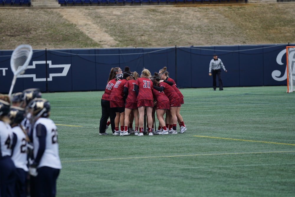 people having huddle in field during daytime