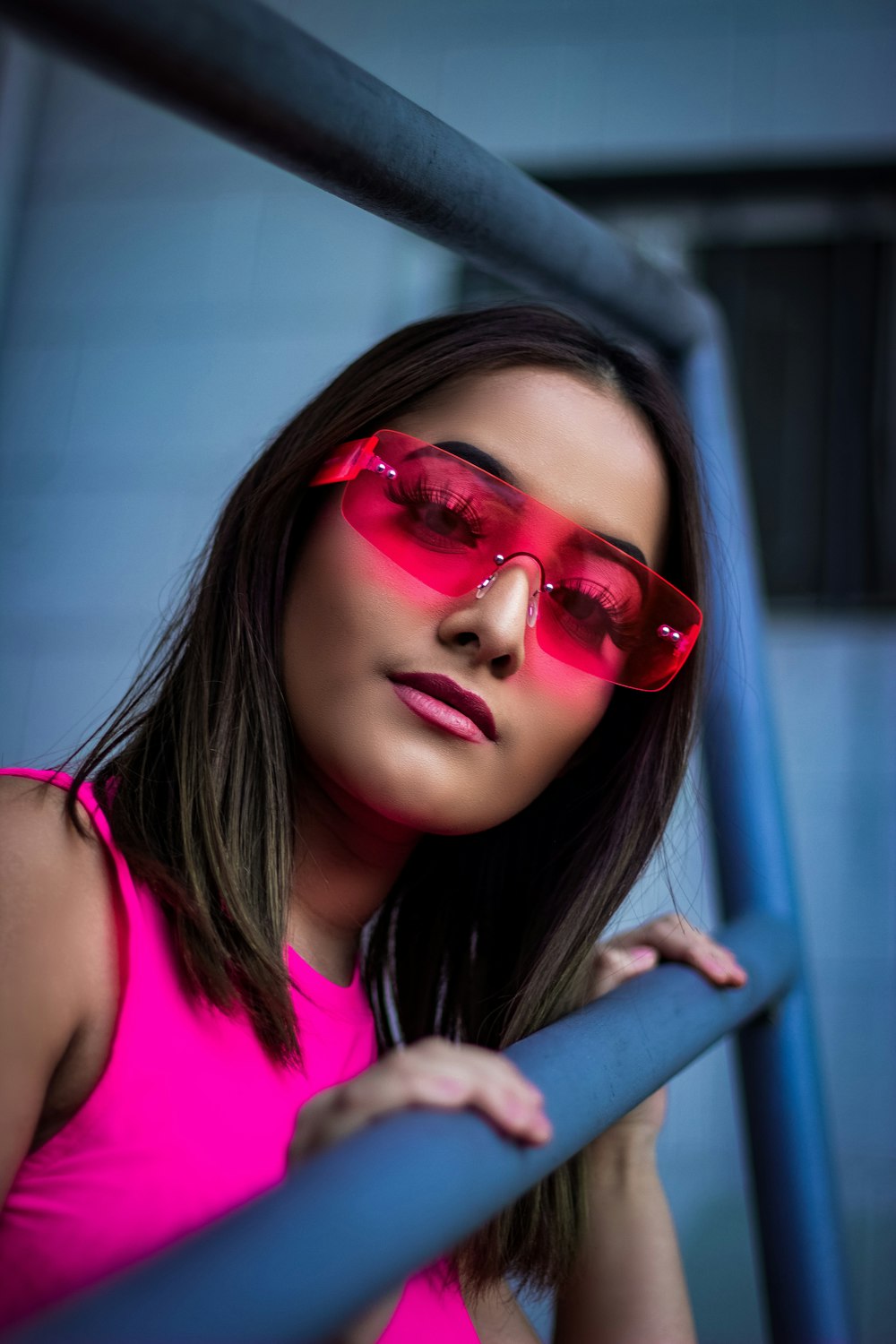 woman wearing pink sunglasses and sleeveless top