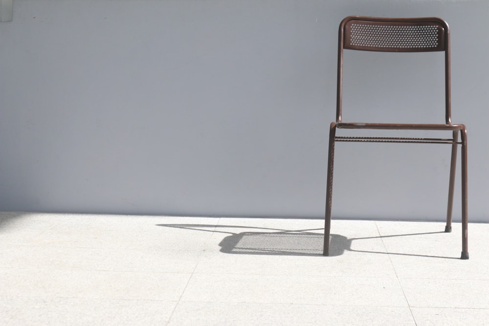vacant brown metal armless chair