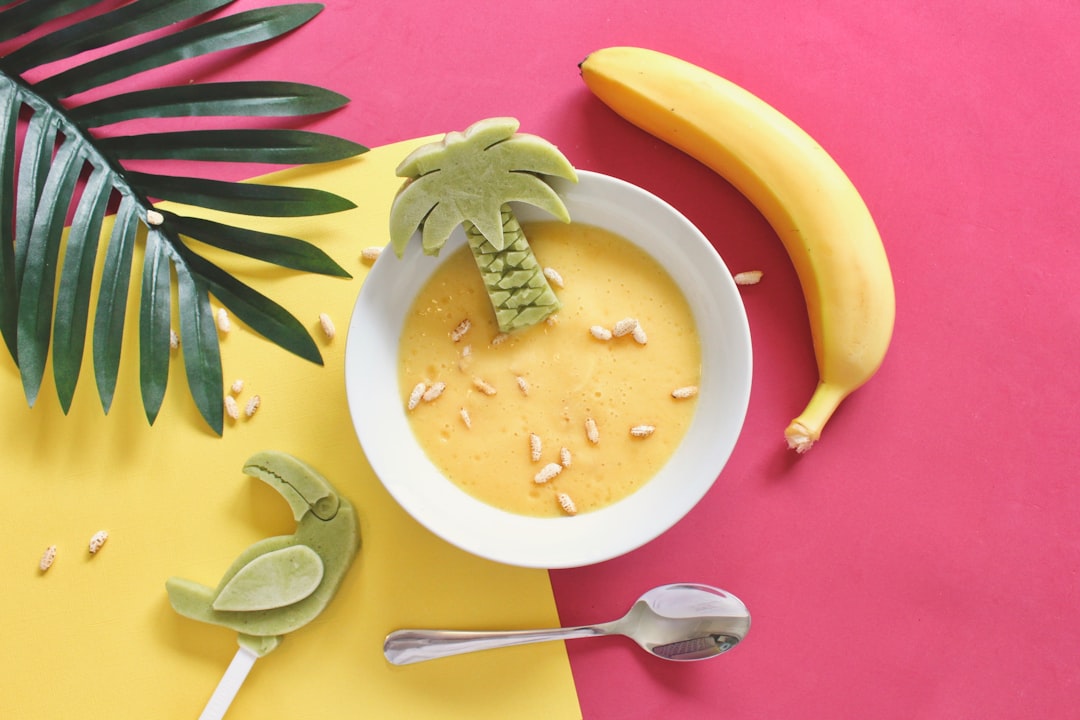  oatmeal on white bowl beside yellow banana ice box